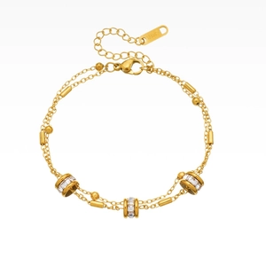Double-layered gold stainless steel bracelet with dainty beads and sparkling crystal pendants