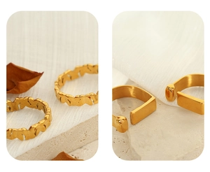 Detail of vintage gold-plated titanium rings featuring floral patterns and minimalist designs
