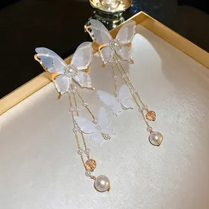 Elegant butterfly tassel earrings with white organza wings, pearls and gold finish