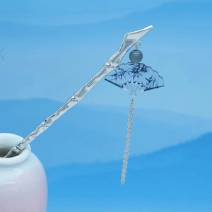 Detailed view of silver bamboo hairpin with blue ink fan pendant and chain tassels