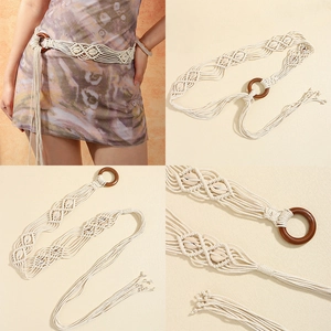 Detail of bohemian hand-woven beige belt with a round wooden buckle and tassel fringe