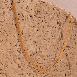 Detailed macro view of 2mm flat blade snake chain necklace with 18K gold plated texture