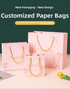 Three premium pink gift bags with floral prints and gold rope handles in various sizes