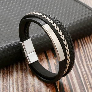 Detail shot of multi-layer black braided leather bracelet with silver magnetic metal clasp