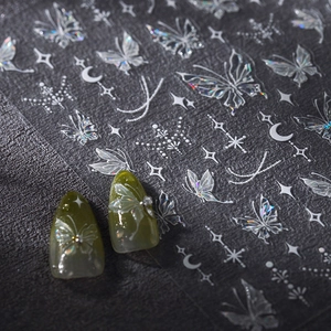 Holographic butterfly nail art stickers with laser silver finish on green manicure nails