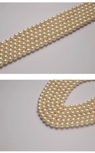Detailed view of high-quality cream white imitation pearls with smooth polished surface
