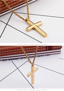 Detailed view of polished gold cross pendant with thick rope chain on display
