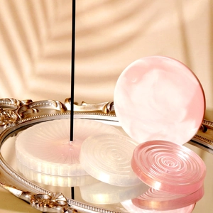 Artistic resin incense tray and coaster set displayed on a vintage mirror tray