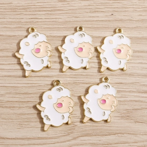 Five cute singing sheep charms with white enamel and gold plating on wood background
