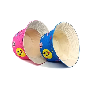 Kids reversible bucket hats with smiley faces in pink and blue canvas fabric