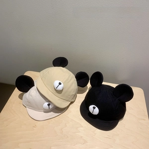 Adorable baby baseball caps with plush ears in beige and black, soft brim design.