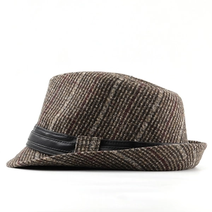 Close-up of vintage brown striped fedora hat with a premium black leather decorative band