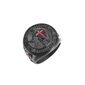 Macro detail of black stainless steel shield ring featuring a red cross and Bible verse