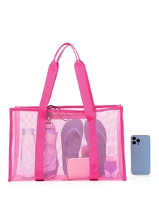 Pink large mesh beach tote bag filled with essentials shown on a white background