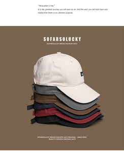 Detailed stack of cotton baseball caps in six colors with minimalist fabric labels