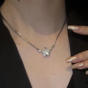 Magnetic pentagram star necklace with sparkling rhinestones in a stainless steel finish