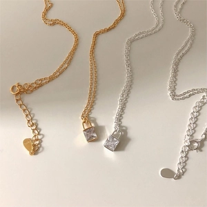 Detail of S925 sterling silver square zircon padlock necklaces in gold and silver