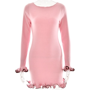 Detail of pink knitted dress with black lettuce edge trim on cuffs and round neckline