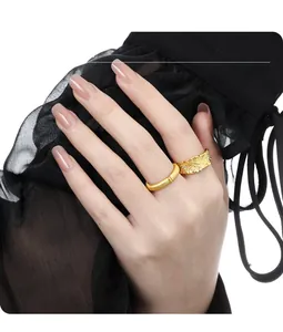 Close-up of stacked gold matte and hammered textured open rings on model hand