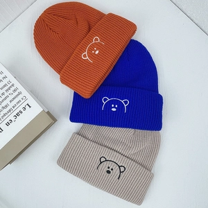 Kids knitted beanie hats with cute bear embroidery in orange blue and beige colors
