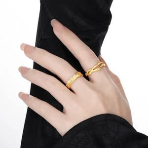 Irregular textured silver ring and branch diamond ring set in gold finish on hand