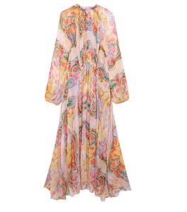 Detail of floral midi dress with long lantern sleeves and flowing pastel printed fabric