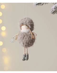 Detail of plush angel girl ornament with long knit legs hanging on a Christmas tree