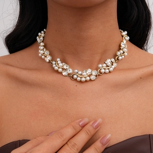 Detailed view of Baroque necklace with pearls and rhinestones on vine shaped metal