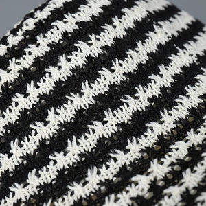 Macro shot of thick black and white striped knit texture on a fisherman bucket hat