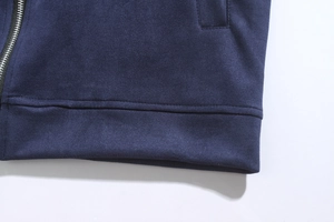 Detail showing high-quality navy blue faux suede fabric and precise double stitching on the hem