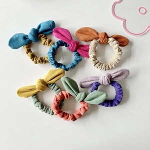 Set of six colorful bow velvet hair ties in blue, pink, yellow, orange and purple hues