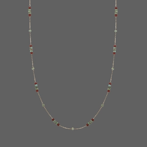 Detail of vintage beaded necklace with red, green and blue beads on a gold chain