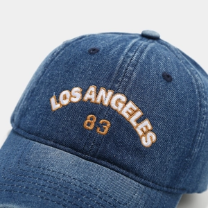 Detailed view of the vintage washed denim fabric and Los Angeles 83 3D embroidery