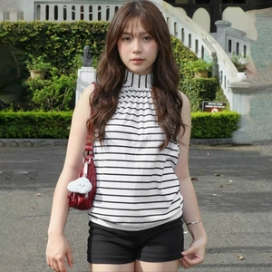 Detail of slim fit black and white striped sleeveless high neck knit vest top