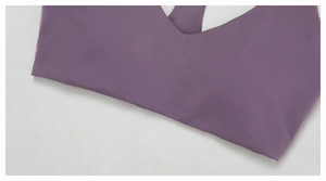 Detail showing the deep V-neckline and smooth stitching of the purple yoga sports bra
