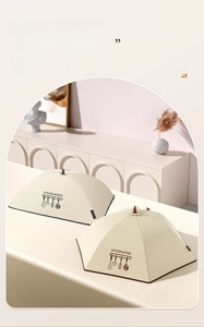 Detail of beige foldable food covers in rectangular and polygonal shapes on a table