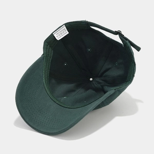 Detail view of cotton baseball cap interior showing white washing label and inner stitching
