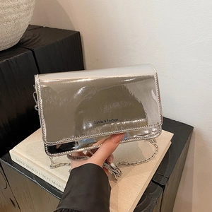 Silver glossy square chain bag for women with metallic finish and minimalist shoulder strap