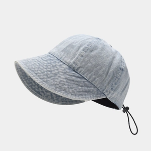 Detailed view of the adjustable drawstring and washed denim texture on a sun hat