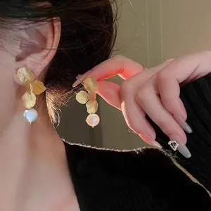 Baroque floral pearl drop earrings featuring gold flower petals and elegant white pearls