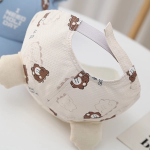 Detail view of the breathable waffle knit fabric and adjustable velcro on infant cap