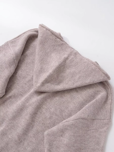 Detail showing knit texture and metal zipper hardware on the gray pink hoodie