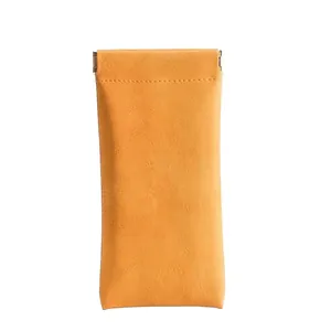 Bright yellow leather sunglasses pouch with metal spring clip and litchi texture