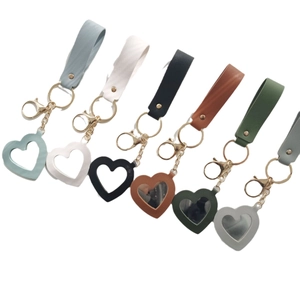 Heart-shaped leather mirror keychains in various colors with golden metal ring hooks