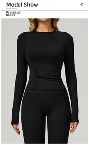 Haut de yoga noir à manches longues avec taille froncée et coupe ajustée