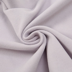 Macro detail of soft light purple ribbed velvet fabric with smooth vertical textures