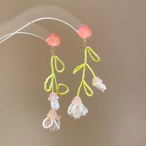Handmade woven earrings featuring pink resin roses and white lily of the valley beads