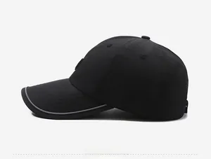 Detail view of black quick-dry baseball cap with extended brim and side ventilation holes