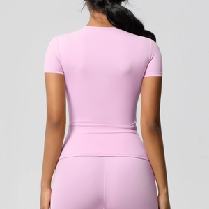 Vue arrière d'un haut de yoga rose ajusté et d'un legging assorti en tissu extensible