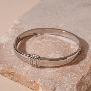 Detailed macro view of silver geometric hinged bangle with micro-pave rectangular crystal insert